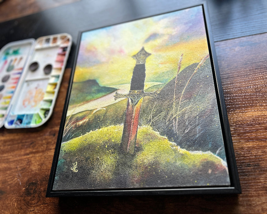 The artwork titled "Legend" portrays a mesmerizing medieval scene, where a magnificent sword is firmly embedded in a weathered stone, symbolizing the strength and destiny of a future ruler. The sword, gleaming in the fading light, rises boldly on a windswept hill, its blade catching the last rays of sunlight. Watercolor painting by Sophie Xie Dream In Watercolor This stunning painting is available as a print on my website, http://www.dreaminwatercolor.com
