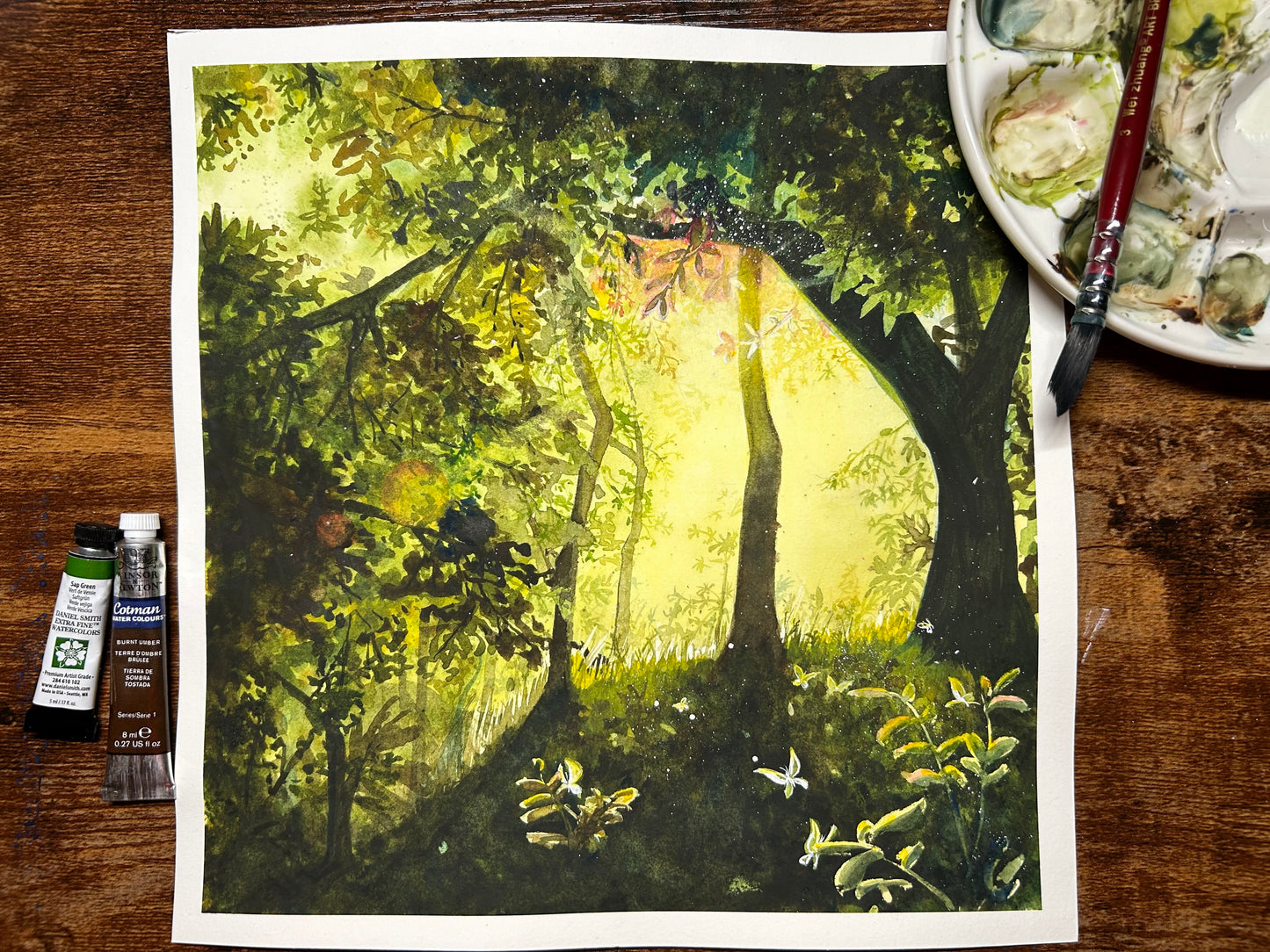 The artwork titled "Butterfly Forest" captures a breathtaking scene within a vibrant, lush forest. Sunlight filters gently through the thick canopy of branches and leaves, casting a warm glow on the forest floor. This illumination reveals a tapestry of delicate butterflies fluttering about.