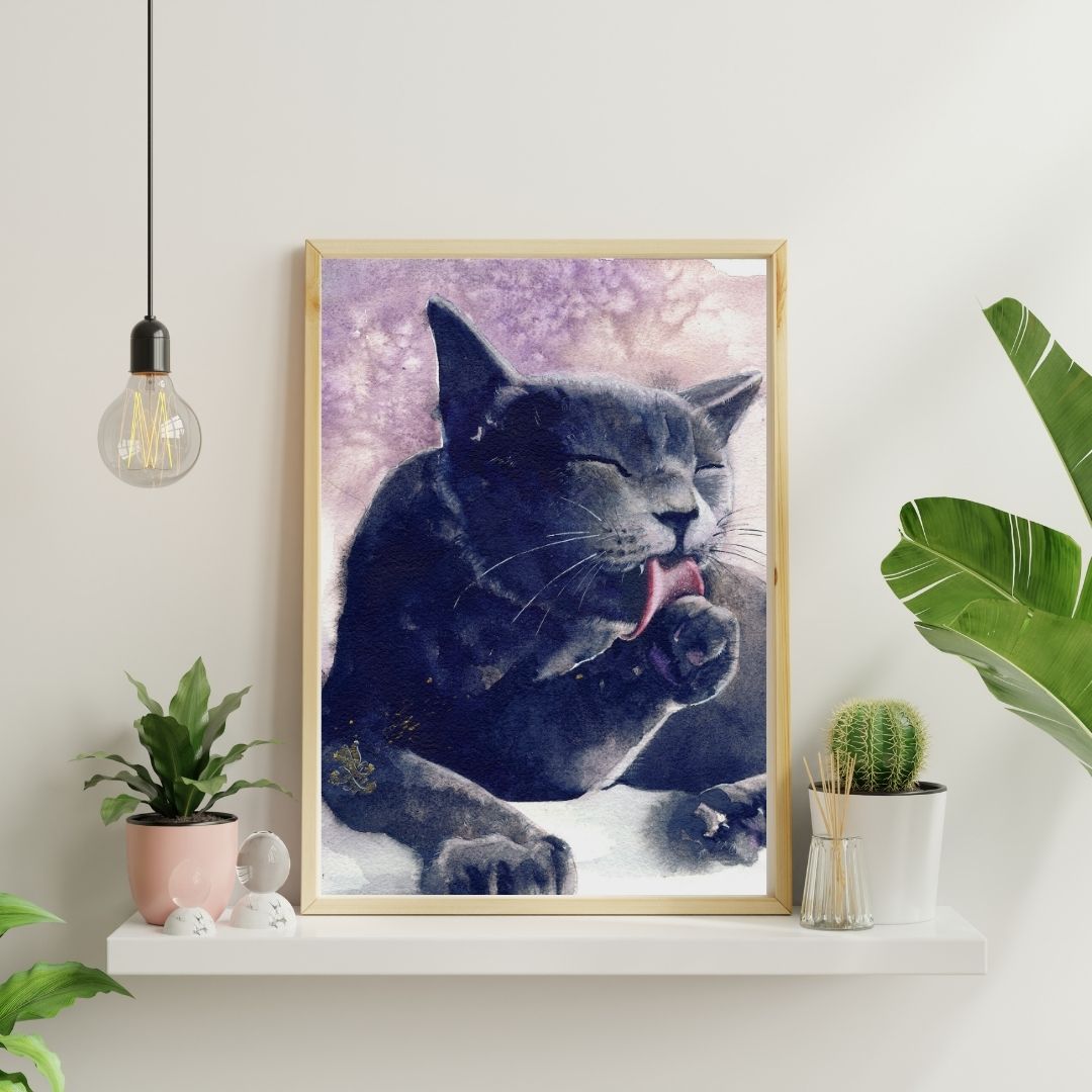 Framed artwork of a cat with a purple gradient background on a white wall with plants and decor. Black Cat portrait Watercolor painting by Sophie Xie Dream In Watercolor. This stunning painting is available as a print on my website, http://www.dreaminwatercolor.com