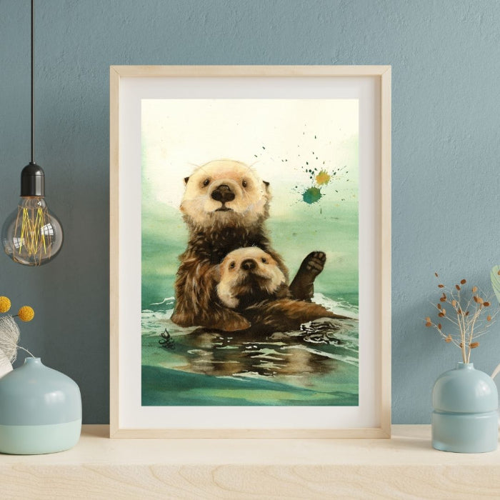 The artwork titled "Sea Otters: Mom and Me" features a cozy painting of a mother and baby sea otter floating in the turquoise sea. Watercolor painting by Sophie Xie Dream In Watercolor. This stunning painting is available as a print on my website, http://www.dreaminwatercolor.com