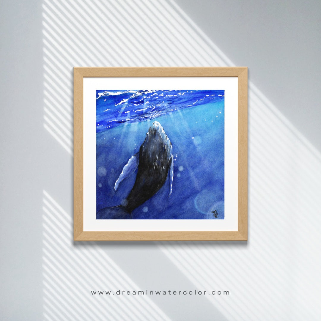 The artwork titled "Whale" vividly illustrates a majestic whale gracefully interacting with the shimmering light that dances across the ocean's surface. The waves gently ripple around it, enhancing the serene and magical atmosphere of this aquatic moment.