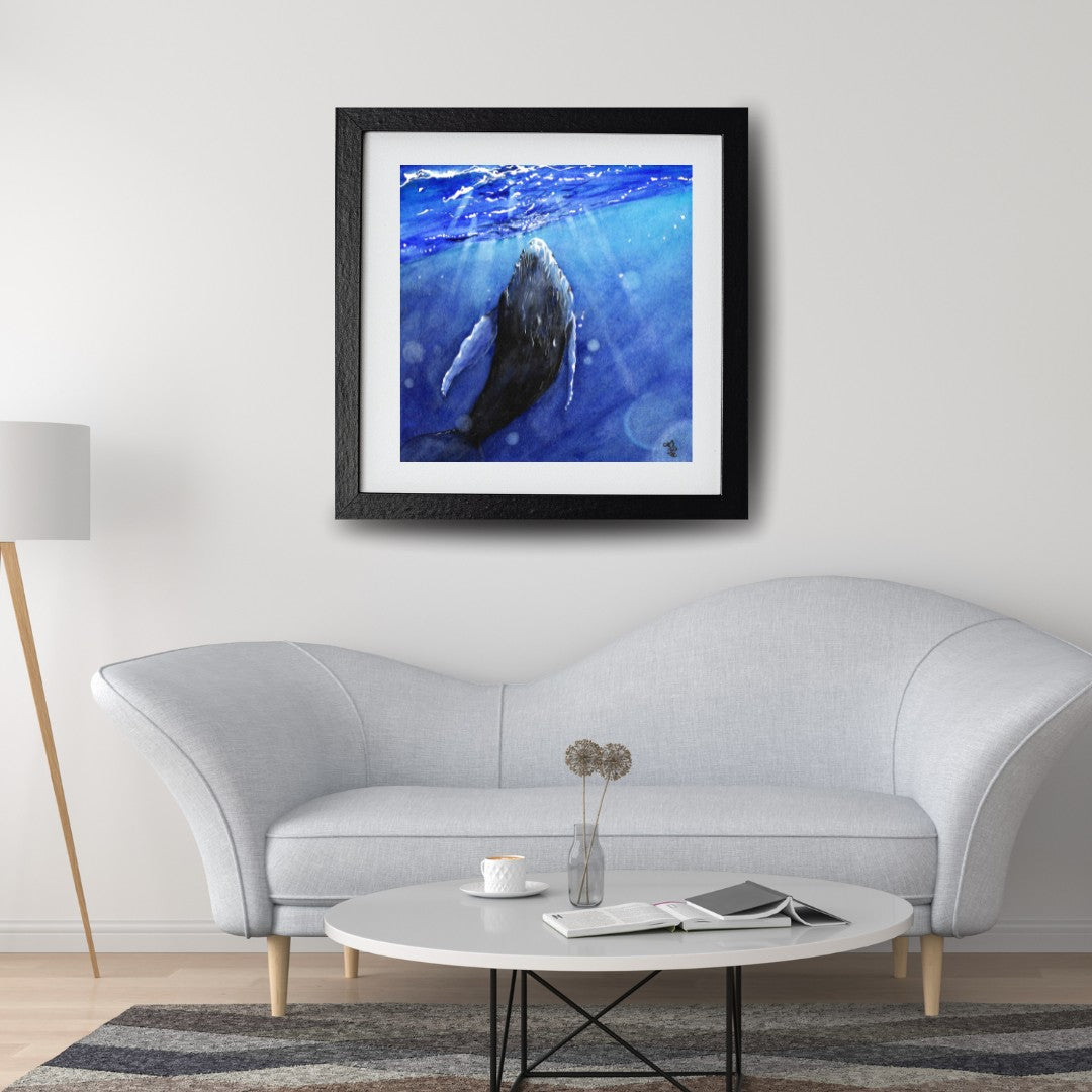 The artwork titled "Whale" vividly illustrates a majestic whale gracefully interacting with the shimmering light that dances across the ocean's surface. The waves gently ripple around it, enhancing the serene and magical atmosphere of this aquatic moment.
